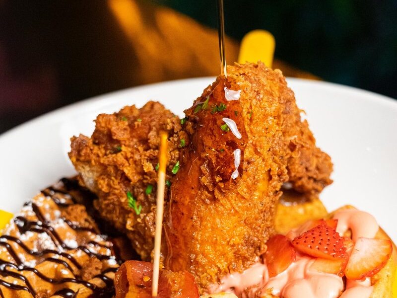 Chicken and waffles with strawberries at Seaside Lounge brunch