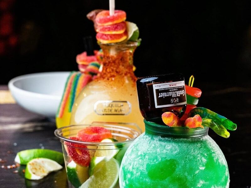 A green frozen cocktail with candy garnish at Seaside Lounge